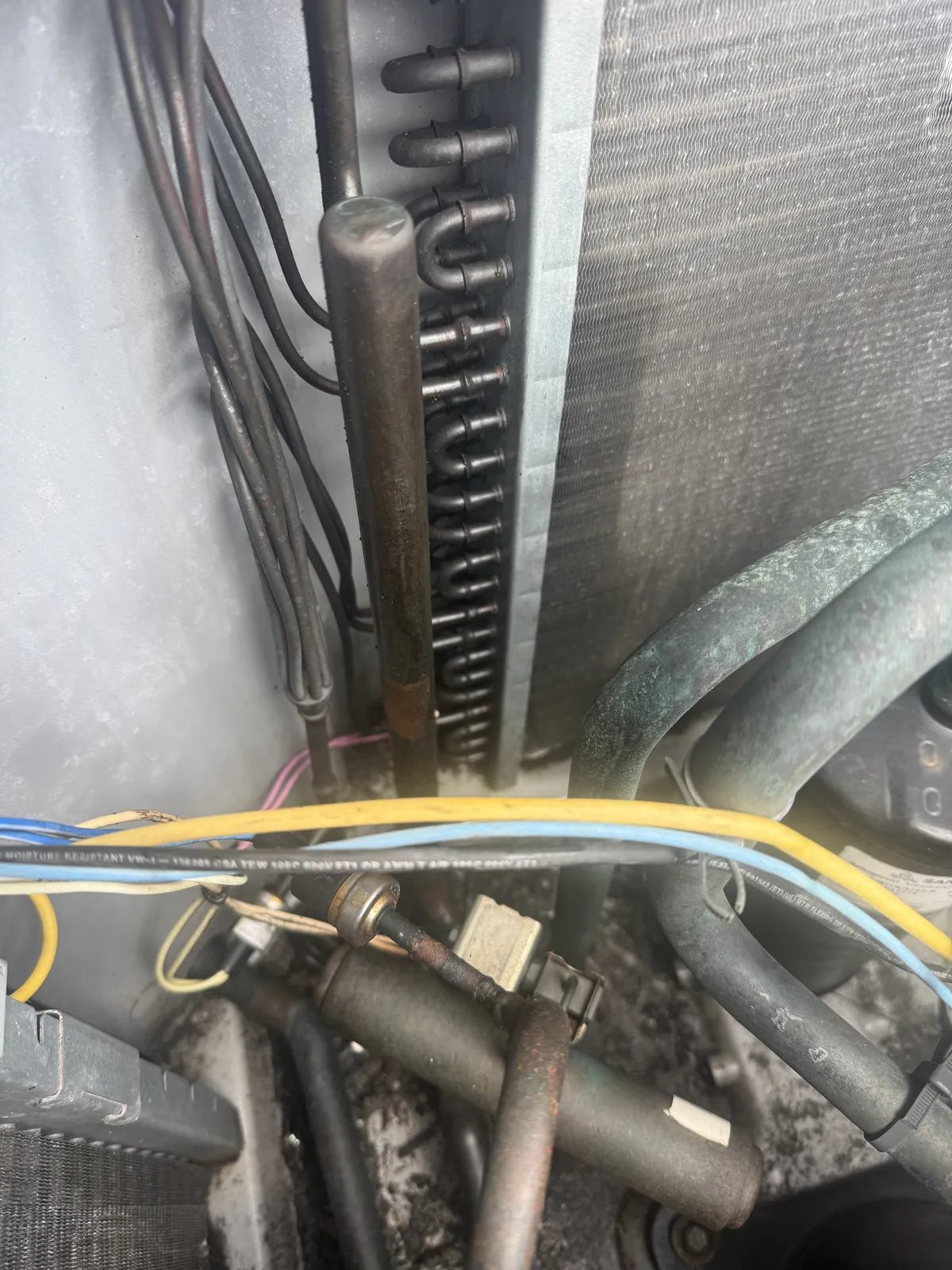 Condenser coil and refrigerant lines inside an outdoor unit in Gulfport with a coil leak